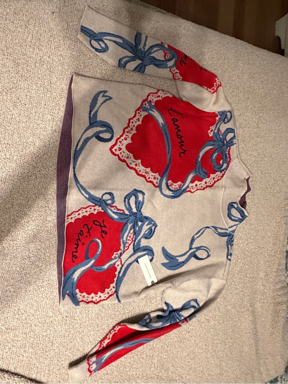 Anthropologie Cream Sweater with Red Heart Motifs and Blue Ribbon Accents